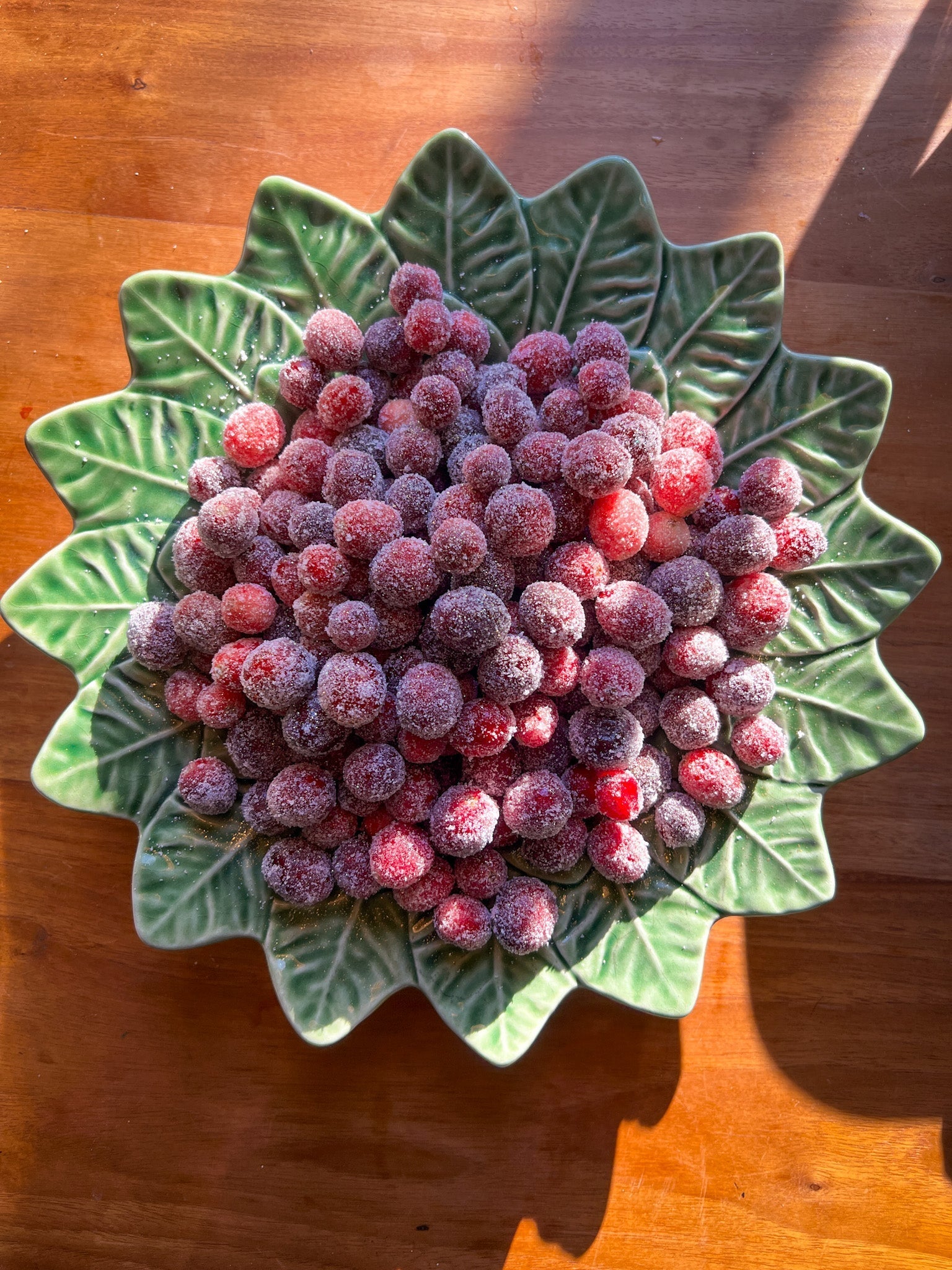 sugared cranberries on a green leaf shape dish