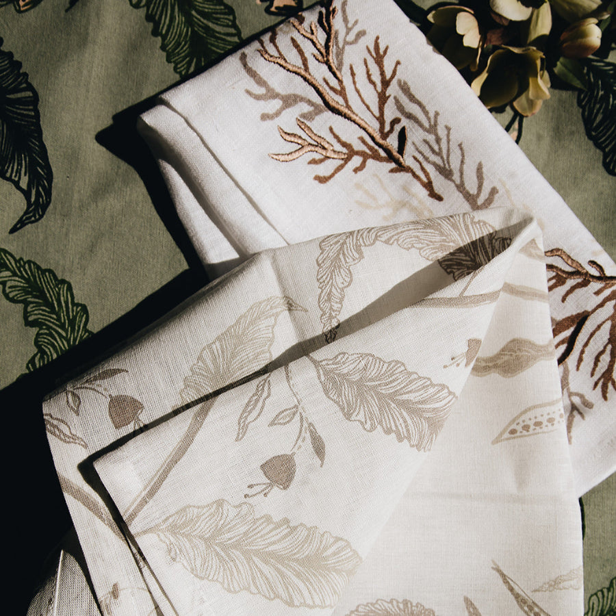 cream and brown napkin with floral and nature detailing