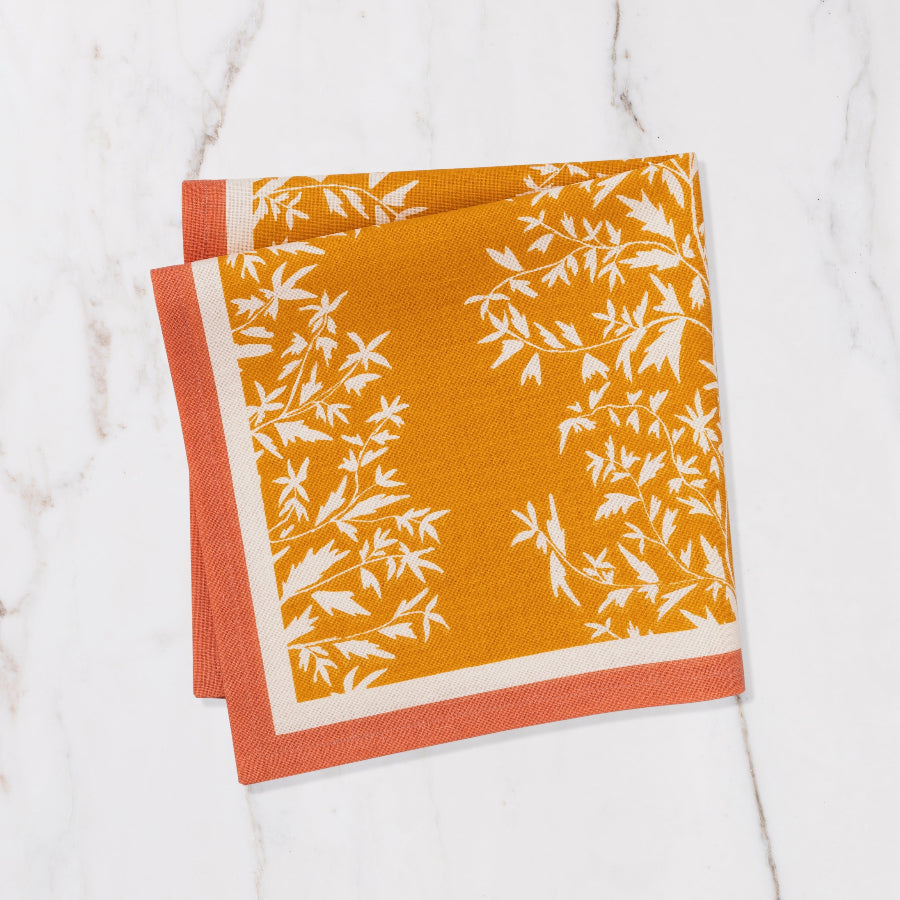 orange and yellow napkin with cream floral details