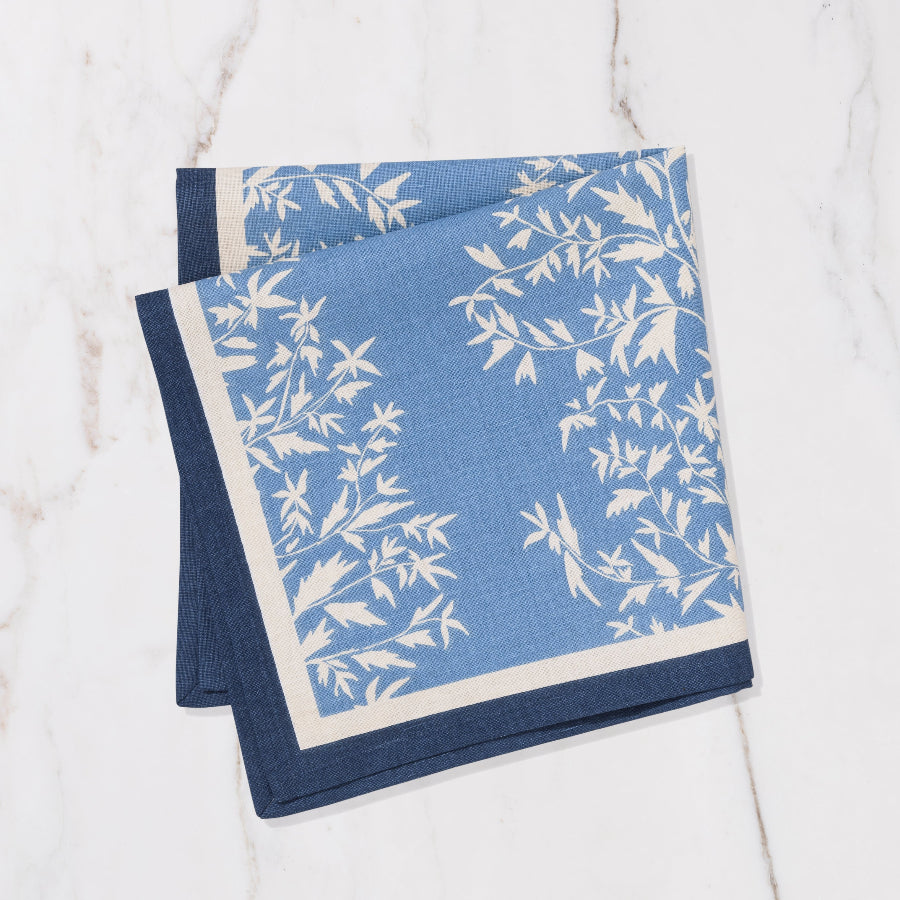 baby blue and navy napkin with cream floral details