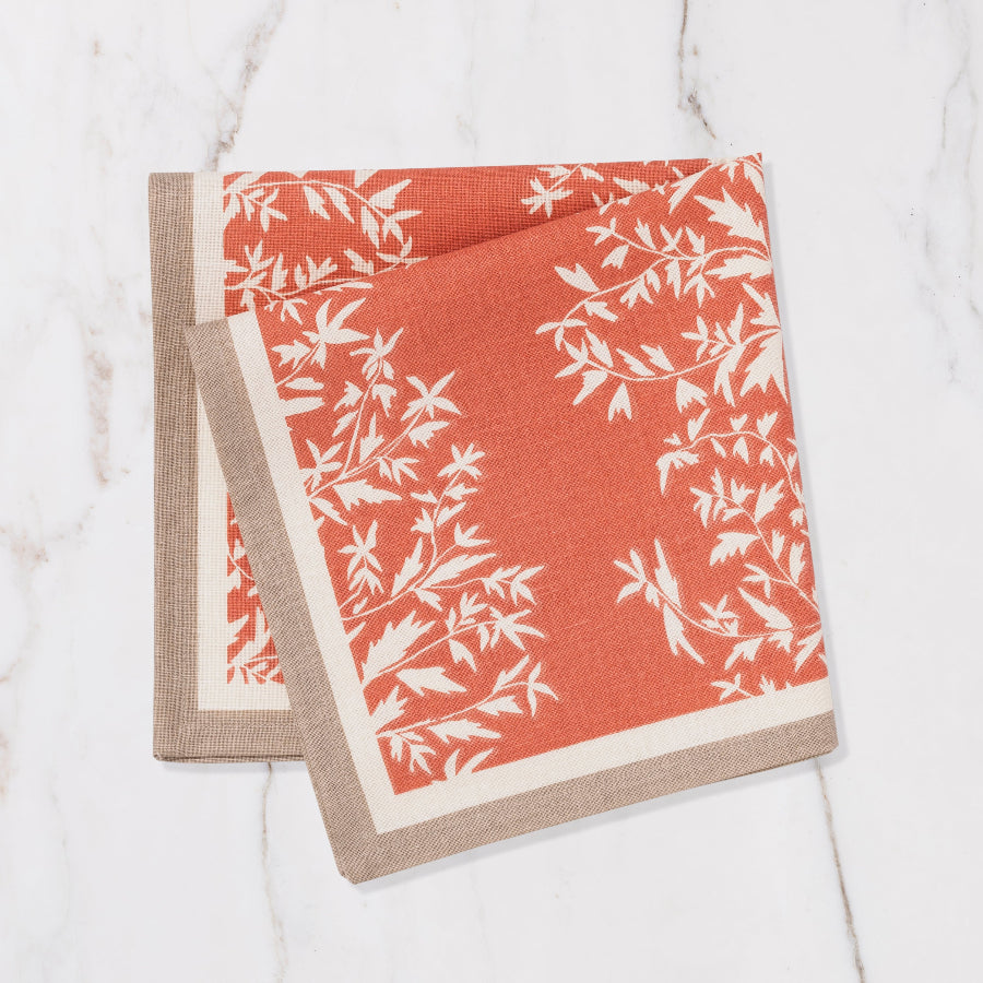 orange and brown napkin with cream floral details