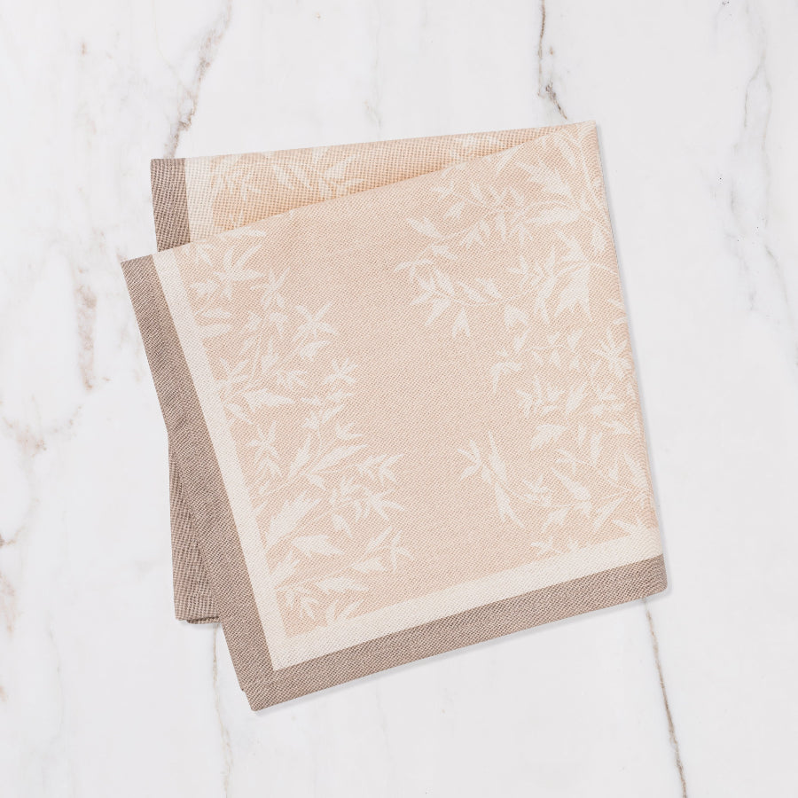 brown and cream napkin with cream floral details