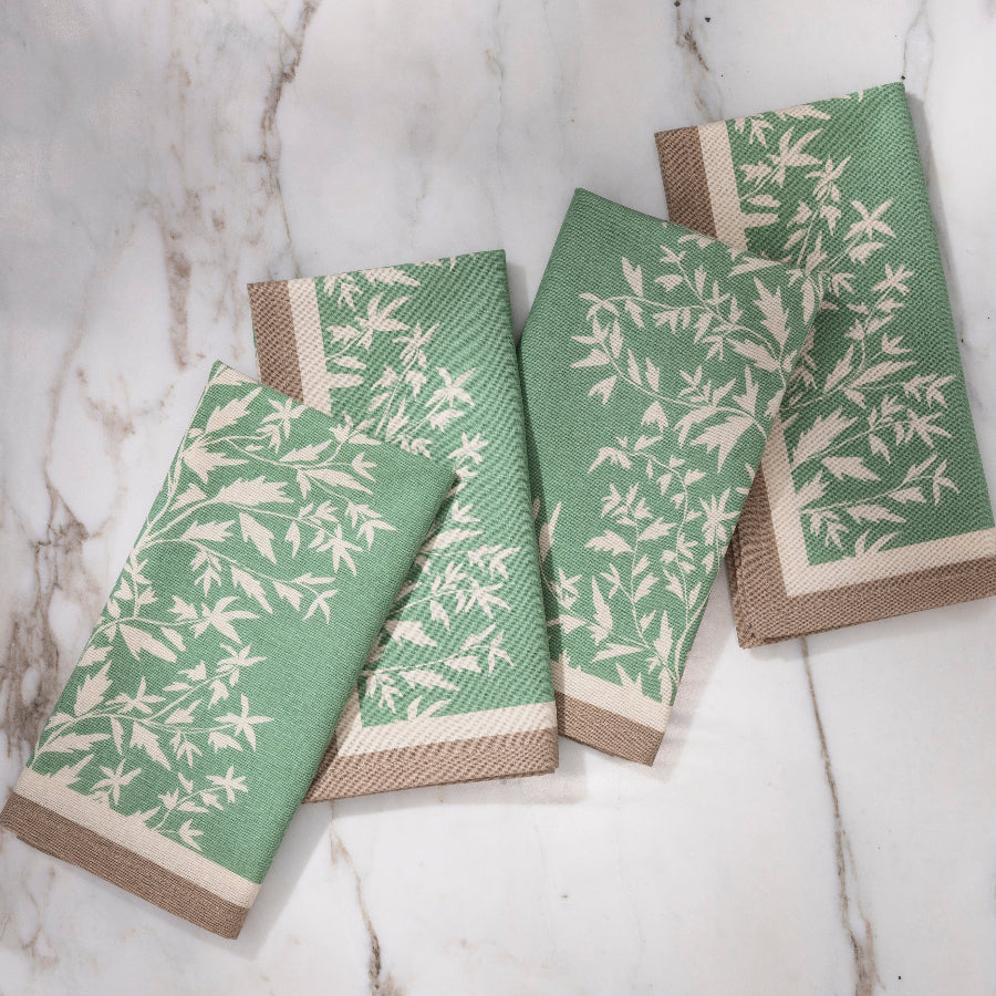 green and brown napkin with cream floral details