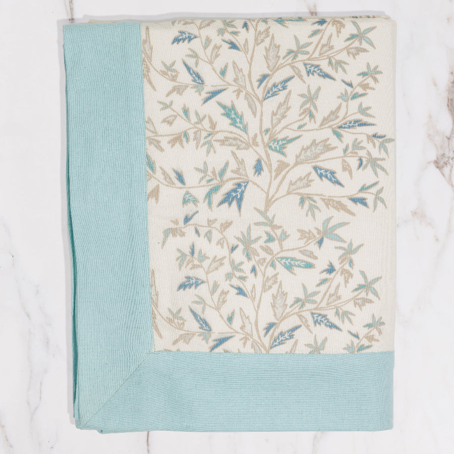 cream tablecloth with blue lining and floral detailing