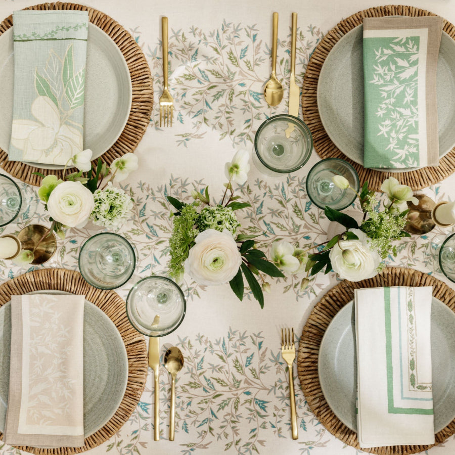cream tablecloth with floral designs and table settings