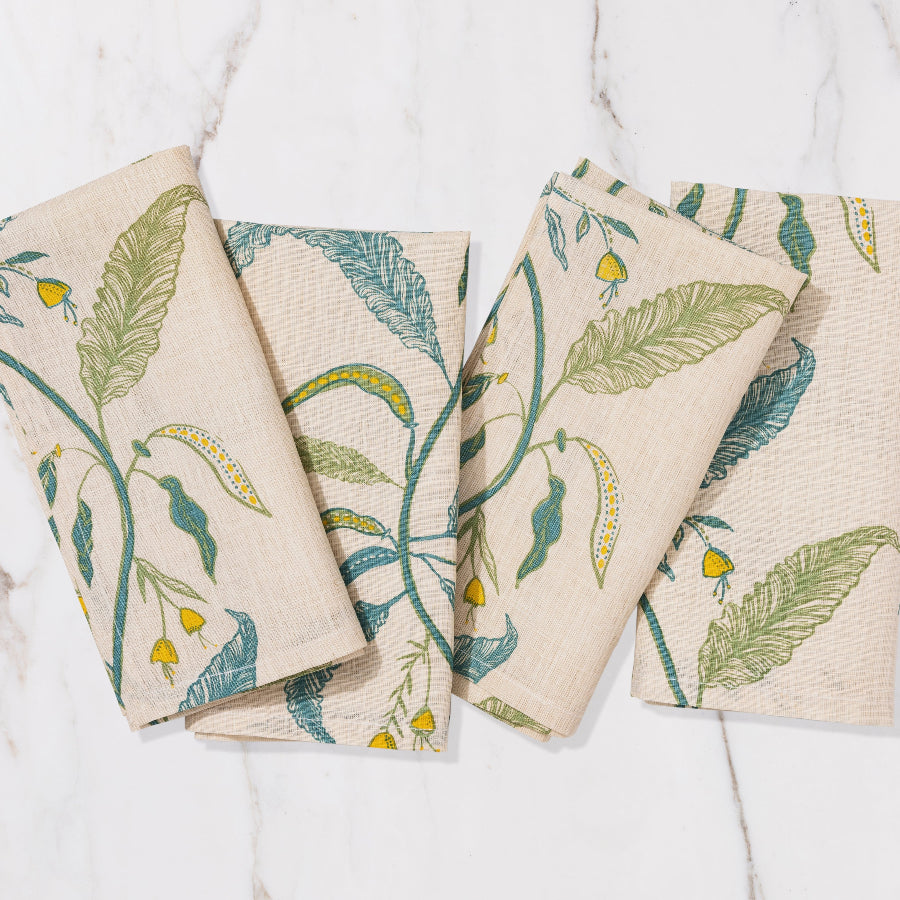 cream, blue and green napkin with floral and nature detailing