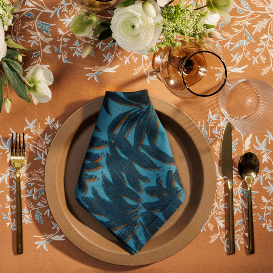 blue napkin on orange tablecloth