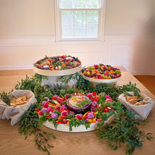 Load image into Gallery viewer, diy cheese and chacuterie boards on a table surrounded by green foliage
